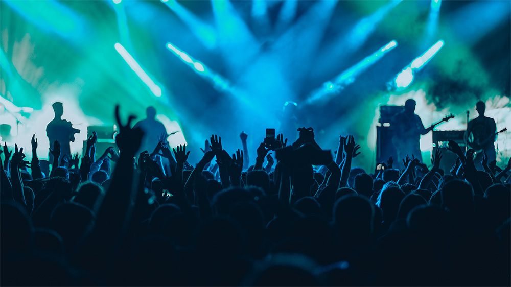 Crowd cheering the band at a rock concert